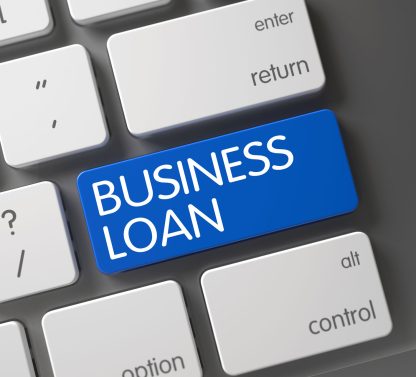 a blue business loan button on a keyboard.